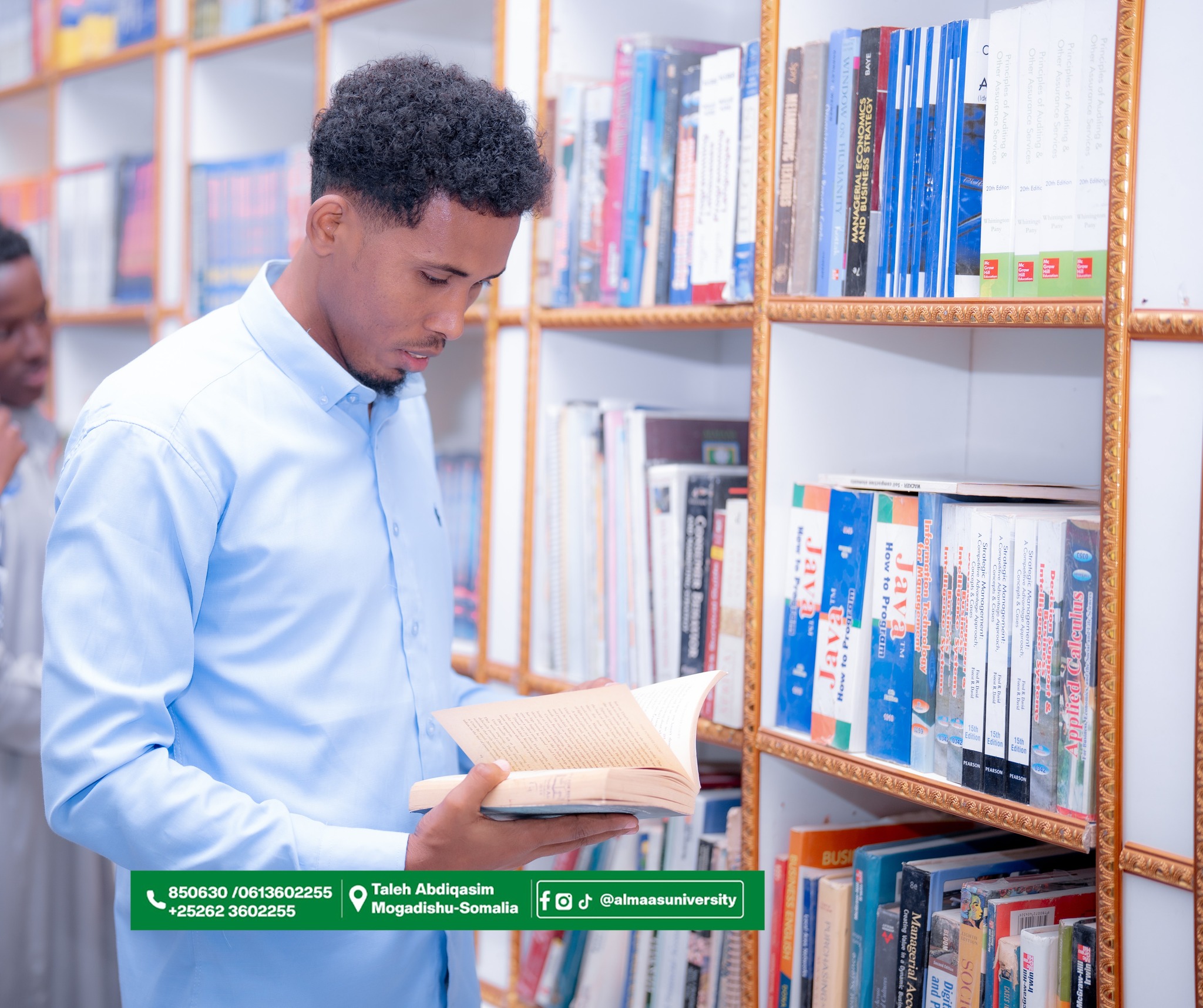Student browsing the shelves at the Almaas University Library